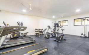 a gym with treadmills and ellipticals in a room at Elna's Baobab Waves - 2BR and 3BR Beachfront Nyali in Mombasa