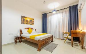a bedroom with a bed and a desk in it at Elna's Baobab Waves - 2BR and 3BR Beachfront Nyali in Mombasa