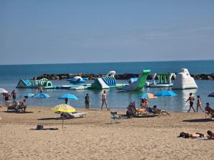 a group of people on a beach with water slides at Casa al Mare Civitanova Marche in Civitanova Marche +2 photos