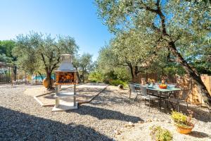 a small playground with a table and a tree at Le Baiser du Soleil - Piscine Privée in Mirabel-aux-Baronnies
