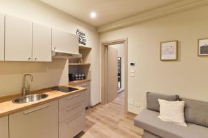a kitchen with a sink and a couch in a room at Antico N19 in Passirano