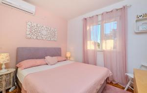 a bedroom with a bed and a window at Villa Hemingway beachfront by Villas Guide in Velika Plana
