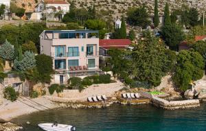 an aerial view of a house with a boat in the water at Villa Hemingway beachfront by Villas Guide in Velika Plana