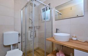 a bathroom with a shower and a toilet and a sink at Villa Hemingway beachfront by Villas Guide in Velika Plana +40 photos