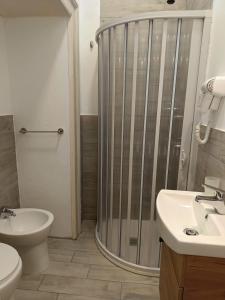 a bathroom with a shower and a toilet and a sink at Residence e appartamenti Rosaroll in Naples