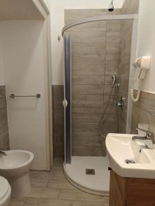 a bathroom with a shower and a toilet and a sink at Residence e appartamenti Rosaroll in Naples
