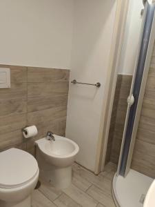 a bathroom with a white toilet and a sink at Residence e appartamenti Rosaroll in Naples +81 photos