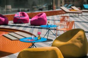 a group of chairs and tables and chairs on a patio at Nhow Milan in Milan