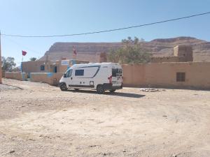 a white van parked in front of a building at Gîte Palma Eagle Ziz Canyon in Er Rachidia