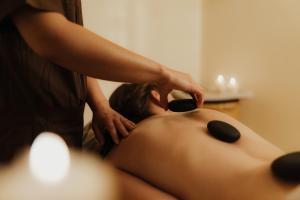 a woman getting her hair cut by a massage therapist at Hotel Colbricon in San Martino di Castrozza