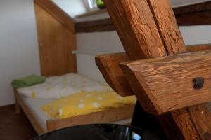 a small bedroom with a bed with yellow sheets at Dom przy Rezerwacie in Trzciel