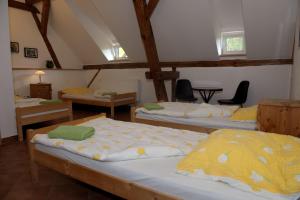 a room with three beds and chairs in it at Dom przy Rezerwacie in Trzciel