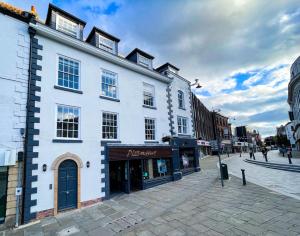 a large white building on a city street at New! 1BR in Horsemarket in Darlington