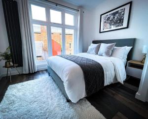 a bedroom with a large bed and a window at New! 1BR in Horsemarket in Darlington