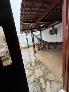 a view of a room with a hammock on a patio at Casa para repouso in Mamanguape