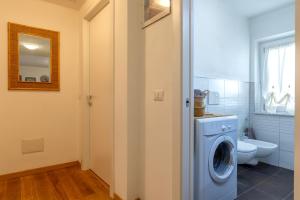 a bathroom with a washing machine and a toilet at Sa Domo de Paolo in Alghero +43 photos