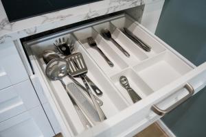 a drawer in a kitchen with silver utensils at Top Rooms Torino in Turin
