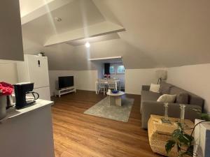 a living room with a couch and a tv at Rudbecksgatan BB in Eskilstuna