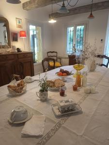 a table with a white table cloth with food on it at villa Léonfine in Le Cannet-des-Maures