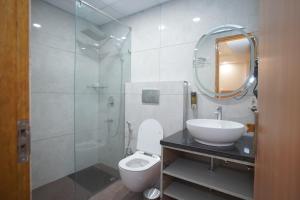 a bathroom with a sink and a toilet and a mirror at Royal Raven Hotel & Banquet' Greater Noida Nearby India Expo Centre & Mart in Greater Noida +164 photos