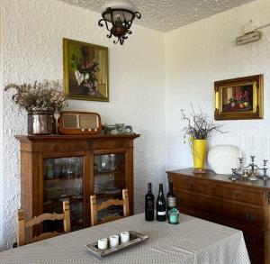a dining room with a table with bottles of wine at Alla Torre Antica in Ruttàrs
