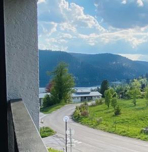 a view of a road with a building and a lake at Studio à Gérardmer, les Dryades in Gérardmer +3 photos