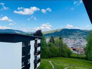 a building with a view of a city at Studio à Gérardmer, les Dryades in Gérardmer