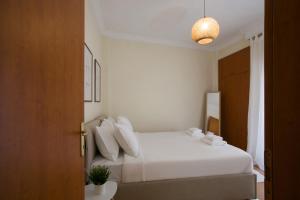 Ένα ή περισσότερα κρεβάτια σε δωμάτιο στο White Cozy Stay