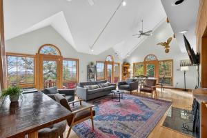 a living room with a couch and a table at Huge 5 Bedroom Modern Cabin wHot Tub, Deck, WiFi in Berkeley Springs +58 photos