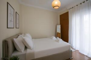 Ένα ή περισσότερα κρεβάτια σε δωμάτιο στο White Cozy Stay