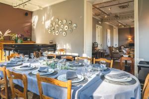 a dining room with a table with a blue table cloth at Villa Adélaïde in Chimay