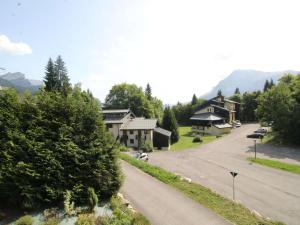 eine Straße, die zu einem Haus in einem Dorf führt in der Unterkunft Chalet typique 10 pers, Arâches-la-Frasse - FR-1-572-27 in Arâches-la-Frasse