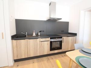 a kitchen with a sink and a stove at Appartement ski aux pieds, 3 pièces, 6 pers, terrasse sud, près des Carroz - FR-1-572-248 in Les Carroz d'Araches