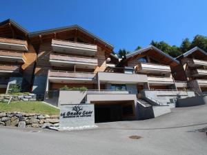 a building with a sign in front of it at Appartement ski aux pieds, 3 pièces, 6 pers, terrasse sud, près des Carroz - FR-1-572-248 in Les Carroz d'Araches