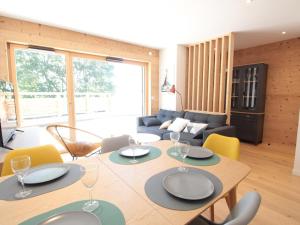 a dining room with a table and chairs at Appartement ski aux pieds, 3 pièces, 6 pers, terrasse sud, près des Carroz - FR-1-572-248 in Les Carroz d'Araches