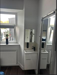 a bathroom with a sink and a mirror and a window at Auld Shebeen in Moate +8 photos