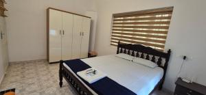 a bedroom with a bed and a large window at Nest&Nook in Ettumānūr +1 photo