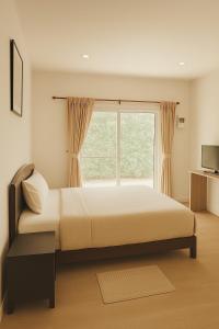 a bedroom with a large bed and a window at Pakmeng Beach Resort in Pak Meng +33 photos