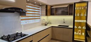 a kitchen with a stove and a counter top at Nest&Nook in Ettumānūr