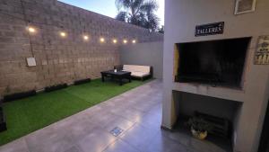 a living room with a fireplace and a television at Dpto en Planta Baja Cba Cap con seguridad in Cordoba