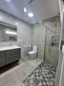 a bathroom with a toilet and a sink and a shower at Casa moderna en Manises con 2 terrazas in Manises