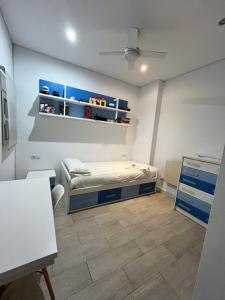 a small room with a bed and a desk at Casa moderna en Manises con 2 terrazas in Manises