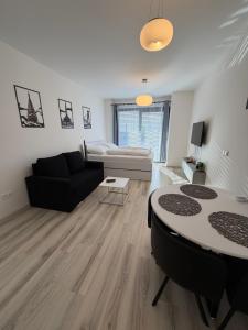 a living room with a couch and a table at Apartmán na NFŠ Bratislava in Bratislava