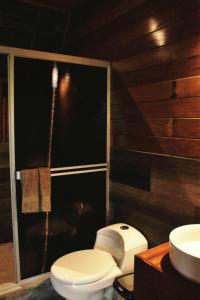 a bathroom with a toilet and a sink at Amazon Uaturi Lodge Iquitos 