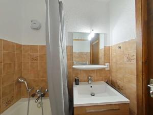 a bathroom with a sink and a bath tub at Studio ski aux pieds avec terrasse, parking et Wi-Fi - 4 couchages - FR-1-241-173 in Le Grand-Bornand