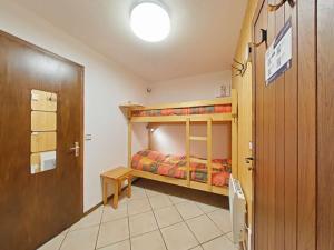 a bedroom with two bunk beds and a door at Studio ski aux pieds avec terrasse, parking et Wi-Fi - 4 couchages - FR-1-241-173 in Le Grand-Bornand