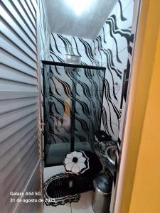 a hallway with a room with a wall with black and white wallpaper at Casa de Praia in Mosqueiro