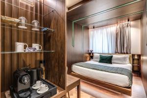 a small bedroom with a bed and a window at THE STEPS Hotel - by Eitch Collection in Rome +92 photos
