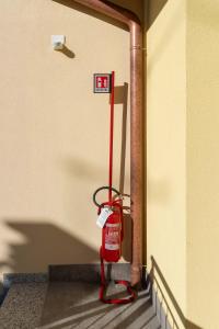 a red fire hydrant in the corner of a building at Bilocale Gelsomino - Cascina Da Rosa in Capiago Intimiano +56 photos