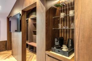 a room with wooden walls and a tv in a room at THE STEPS Hotel - by Eitch Collection in Rome